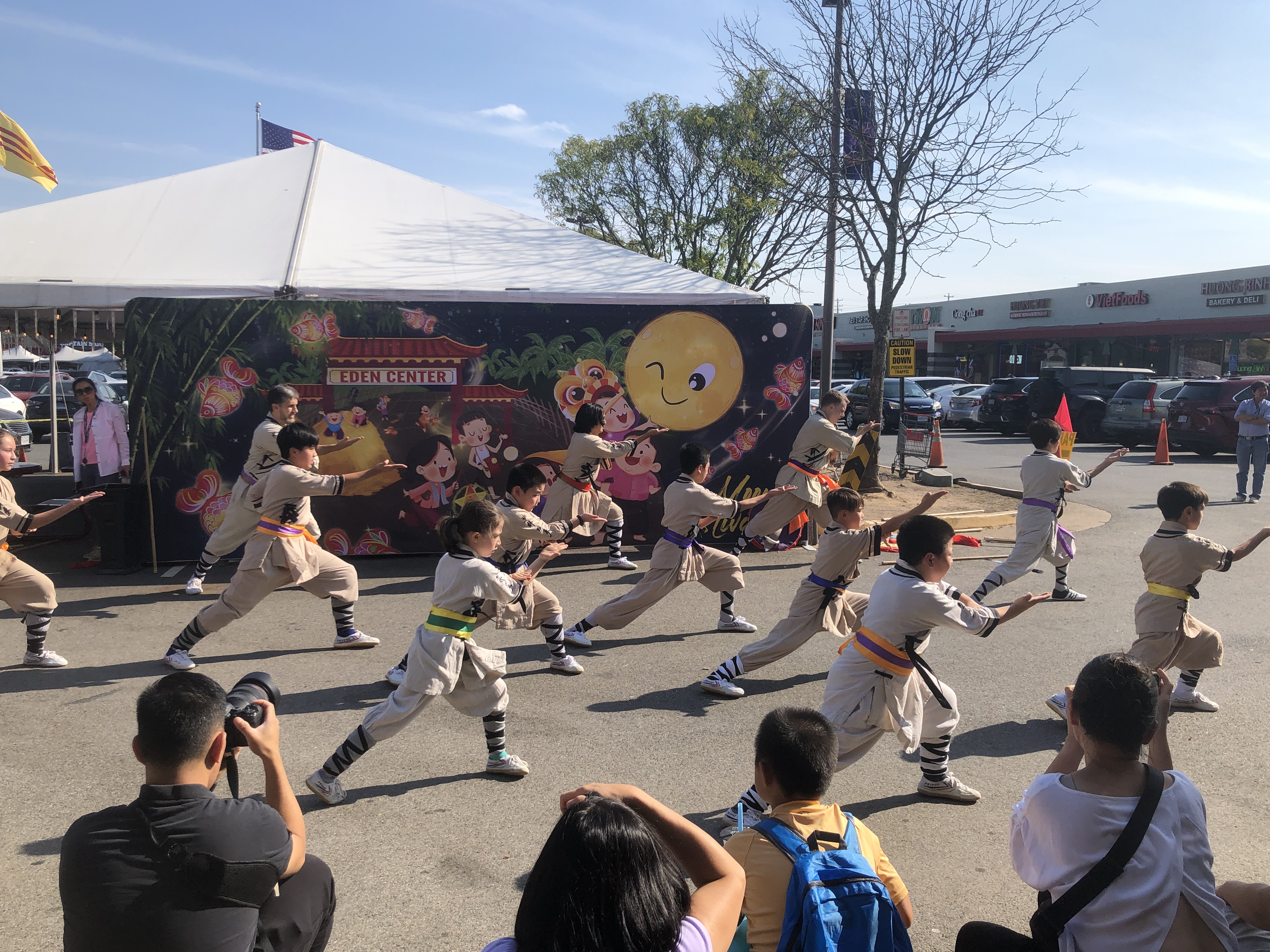 Kids and adult teams performing group fist